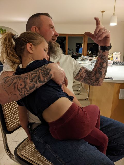 Danny holding a child on his lap during a family gathering at Basic Industries.