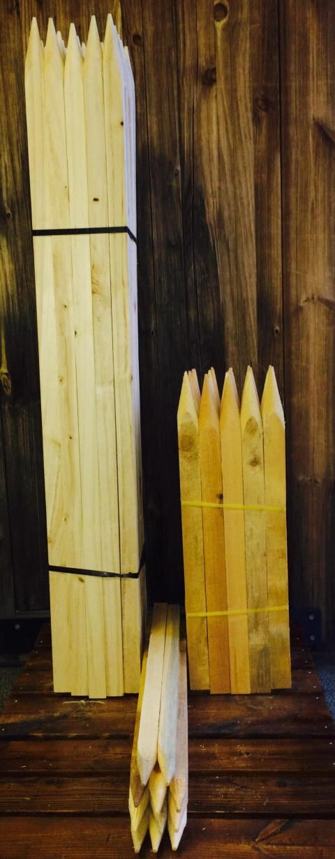 Bundled stakes posed against a dark wood backdrop.