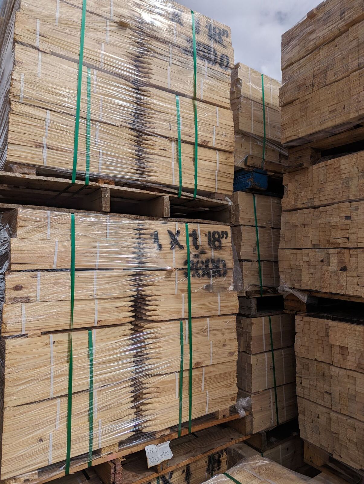 Wrapped pallets of pointed 1x1 stakes ready to ship.