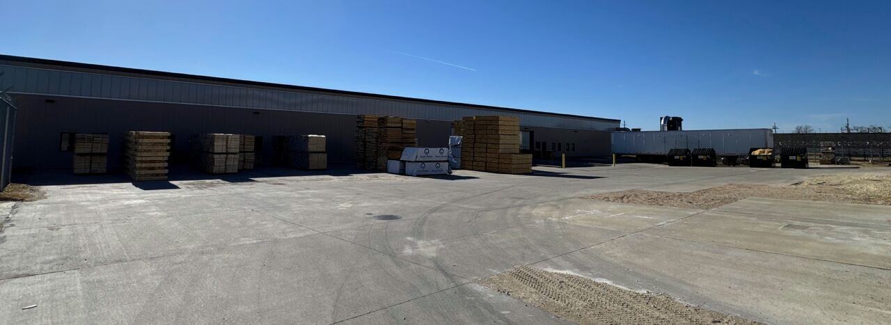Basic Industries shop and yard with pallets of stakes.